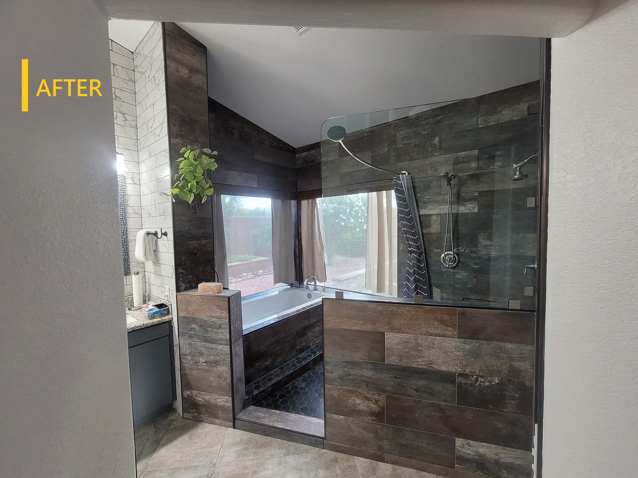 Completed walk-in shower with large-format slate tile and glass enclosure