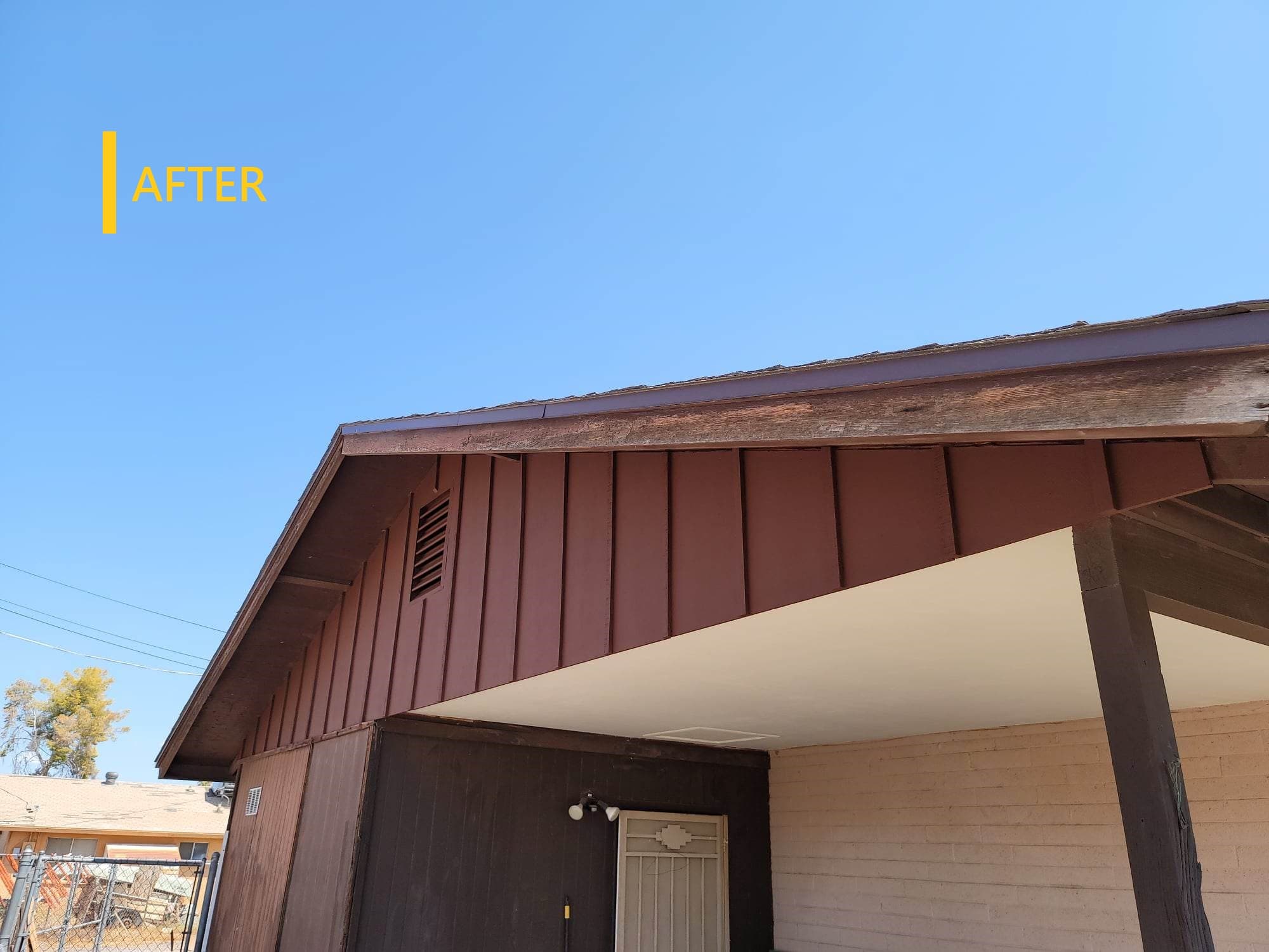 Completed addition with standing-seam metal roof and stucco exterior